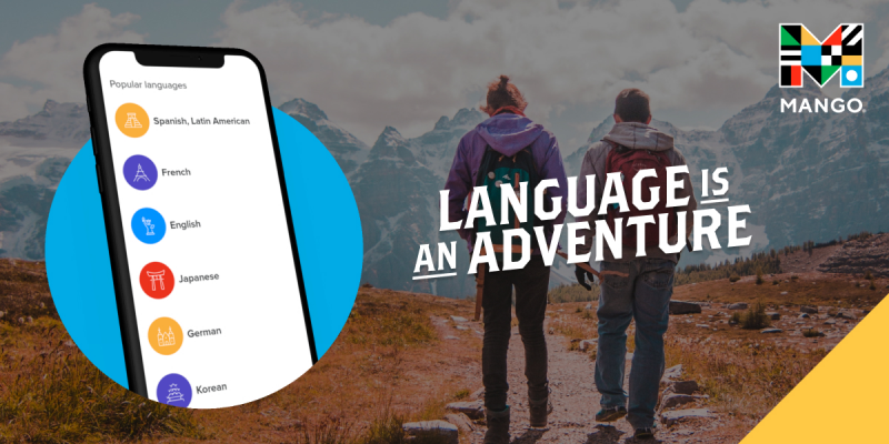 Two persons hiking on a trail. Smartphone at the forefront. Manog Languages logo. Text: Language is an adventure